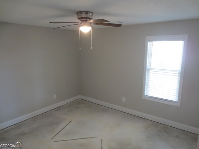 505 Palomino Ln, Warner Robins, GA 31088 - spare room with unfinished concrete floors, baseboards, plenty of natural light, and ceiling fan