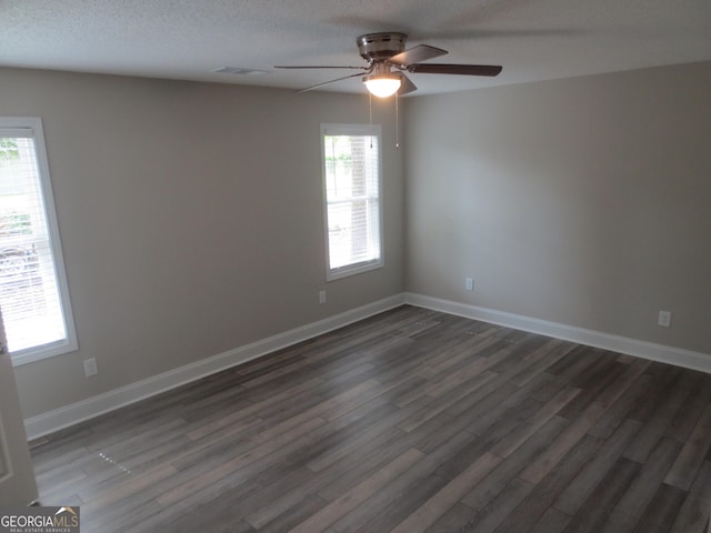 505 Palomino Ln, Warner Robins, GA 31088 - unfurnished room with ceiling fan, plenty of natural light, dark wood-style flooring, baseboards, and a textured ceiling