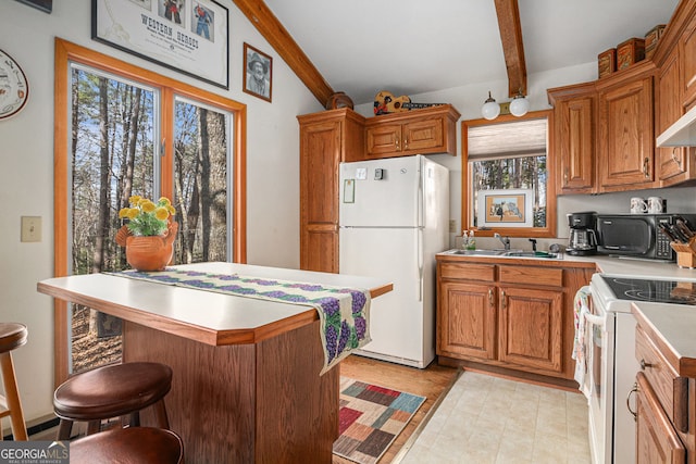 kitchen featuring a sink, beam ceiling, white appliances, brown cabinetry, and light countertops