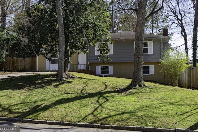 2666 Frontier Trl, Atlanta, GA 30341 - tri-level home featuring a front lawn, a chimney, and fence