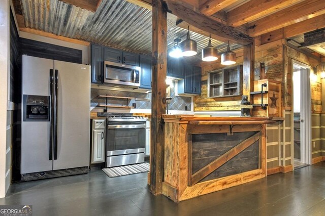 kitchen featuring backsplash, stainless steel appliances, and beamed ceiling