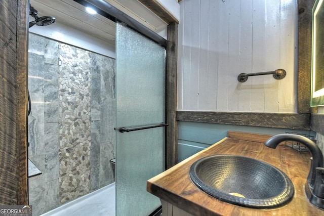 bathroom with vanity and tiled shower