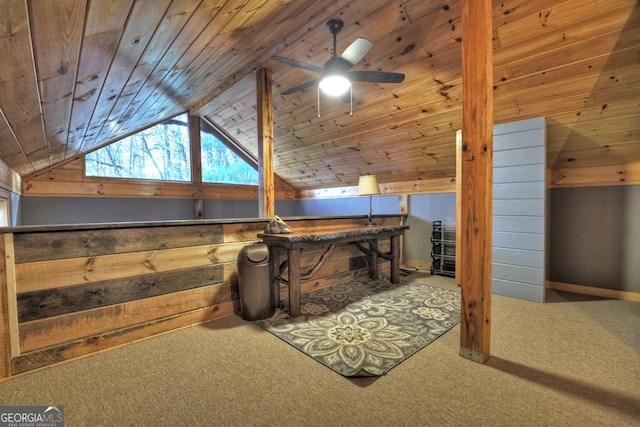 interior space featuring vaulted ceiling, wooden ceiling, carpet, baseboards, and a ceiling fan