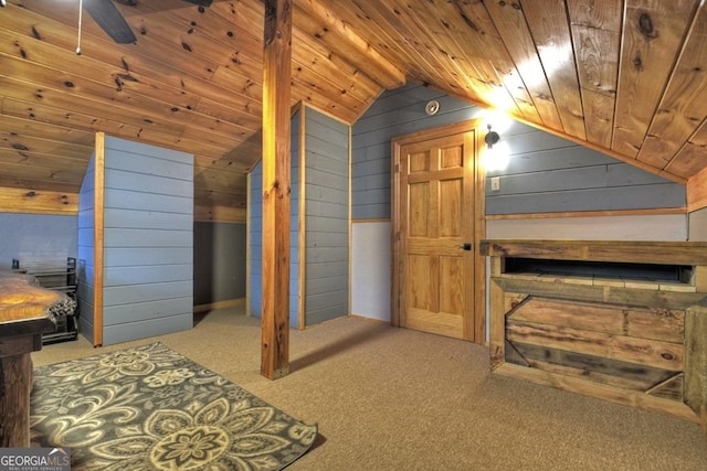bonus room with vaulted ceiling, wooden walls, wooden ceiling, and carpet flooring