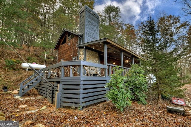 rear view of property with a chimney