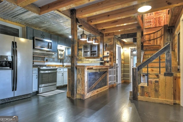 kitchen featuring dark wood-type flooring, pendant lighting, tasteful backsplash, and appliances with stainless steel finishes