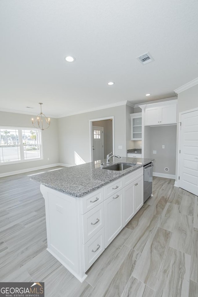 114 Richard Lee Dr, Kingsland, GA 31548 - kitchen with stainless steel dishwasher, ornamental molding, a kitchen island with sink, white cabinets, and a chandelier