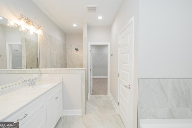 114 Richard Lee Dr, Kingsland, GA 31548 - full bath with vanity, a walk in closet, marble look tile flooring, tiled shower, and recessed lighting