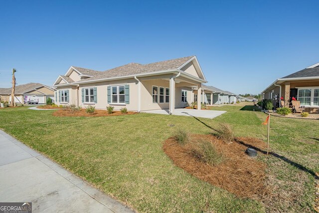 114 Richard Lee Dr, Kingsland, GA 31548 - view of front facade with a front lawn and stucco siding