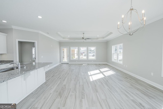 114 Richard Lee Dr, Kingsland, GA 31548 - unfurnished living room featuring crown molding, recessed lighting, ceiling fan, a raised ceiling, and a chandelier