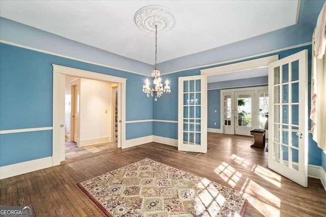 2265 E Lake Rd NE, Atlanta, GA 30307 - unfurnished dining area featuring baseboards, french doors, and hardwood / wood-style floors