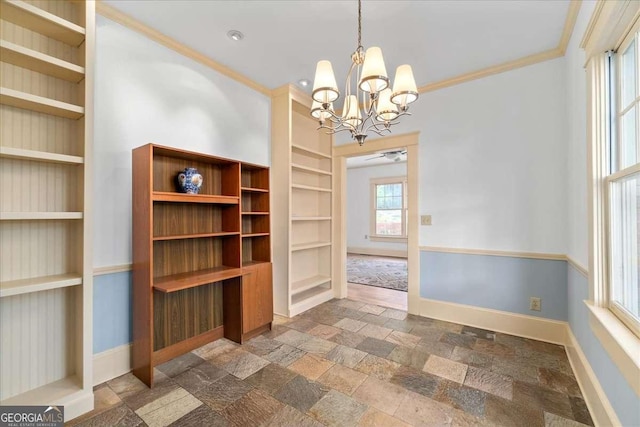 2265 E Lake Rd NE, Atlanta, GA 30307 - unfurnished dining area featuring baseboards, built in shelves, an inviting chandelier, and stone tile floors