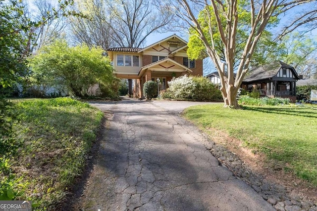 2265 E Lake Rd NE, Atlanta, GA 30307 - view of front of home featuring a front yard, brick siding, and aphalt driveway