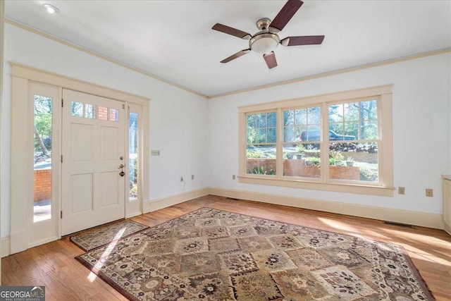 2265 E Lake Rd NE, Atlanta, GA 30307 - entrance foyer featuring light wood-style flooring, ornamental molding, baseboards, and ceiling fan