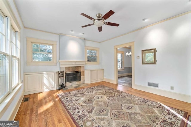 2265 E Lake Rd NE, Atlanta, GA 30307 - living area featuring visible vents, a tiled fireplace, ceiling fan with notable chandelier, and wood finished floors