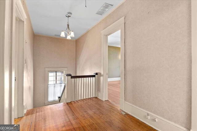 2265 E Lake Rd NE, Atlanta, GA 30307 - spare room with visible vents, a chandelier, and hardwood / wood-style flooring