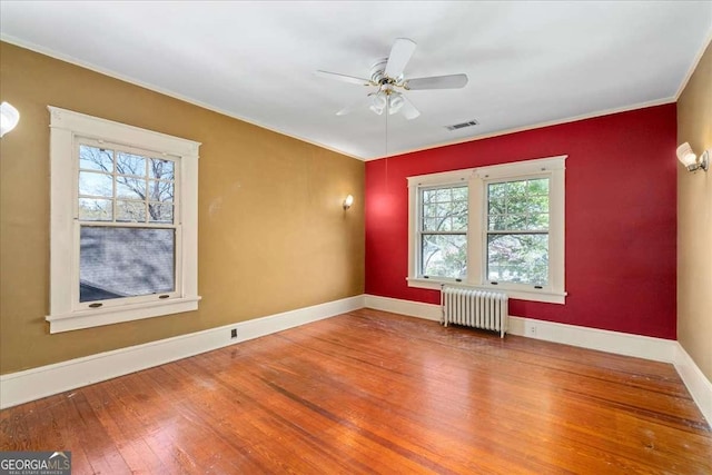 2265 E Lake Rd NE, Atlanta, GA 30307 - unfurnished room with radiator, wood-type flooring, baseboards, visible vents, and ceiling fan