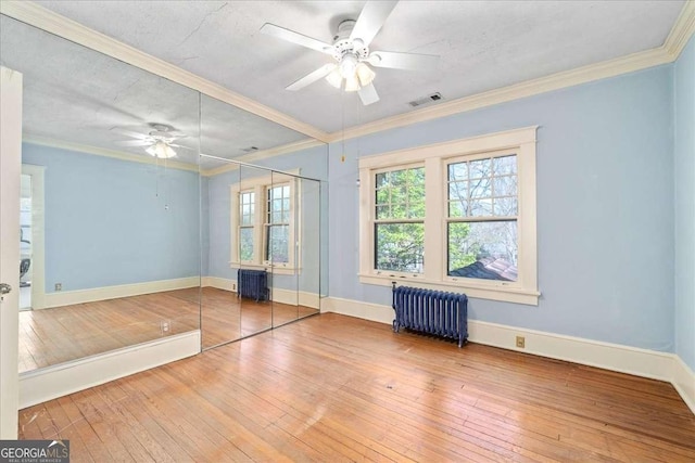 2265 E Lake Rd NE, Atlanta, GA 30307 - empty room featuring visible vents, crown molding, hardwood / wood-style flooring, ceiling fan, and radiator