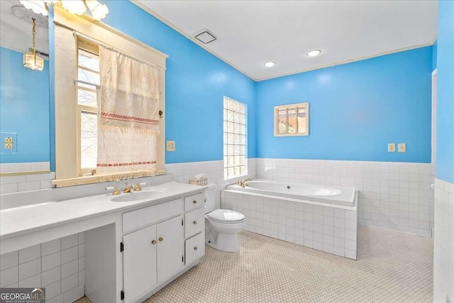 2265 E Lake Rd NE, Atlanta, GA 30307 - full bathroom with tile patterned floors, vanity, a bath, visible vents, and tile walls