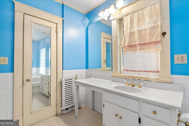 2265 E Lake Rd NE, Atlanta, GA 30307 - bathroom with wainscoting, crown molding, vanity, and tile walls