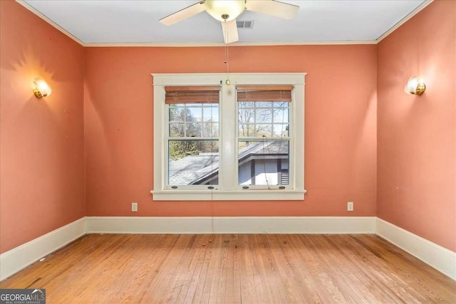 2265 E Lake Rd NE, Atlanta, GA 30307 - empty room featuring baseboards, wood finished floors, ornamental molding, and a ceiling fan