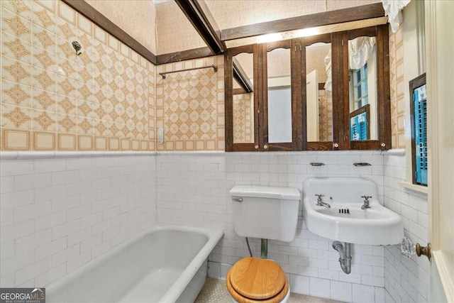 2265 E Lake Rd NE, Atlanta, GA 30307 - full bath featuring a tub to relax in, a sink, wainscoting, wallpapered walls, and tile walls