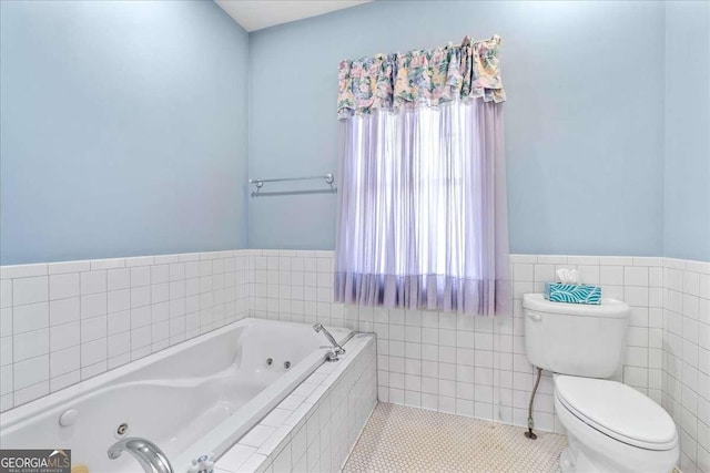 2265 E Lake Rd NE, Atlanta, GA 30307 - full bathroom with tile patterned floors, toilet, a jetted tub, wainscoting, and tile walls