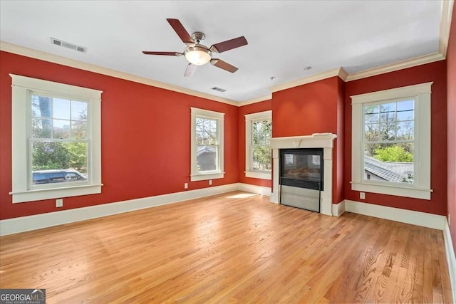 2265 E Lake Rd NE, Atlanta, GA 30307 - unfurnished living room featuring visible vents, a high end fireplace, light wood-style flooring, and ornamental molding
