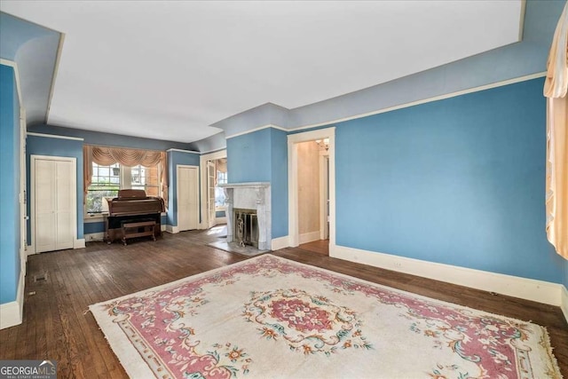 2265 E Lake Rd NE, Atlanta, GA 30307 - unfurnished bedroom featuring baseboards, a fireplace with flush hearth, and dark wood finished floors