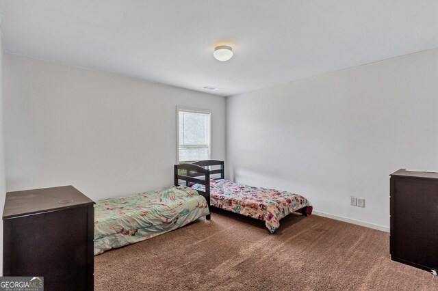 bedroom featuring carpet, visible vents, and baseboards