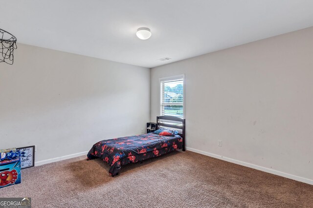 carpeted bedroom with baseboards and visible vents