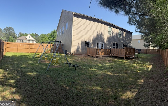 1606 Kenilworth Ln SE, Conyers, GA 30013 - rear view of property featuring a playground and a deck