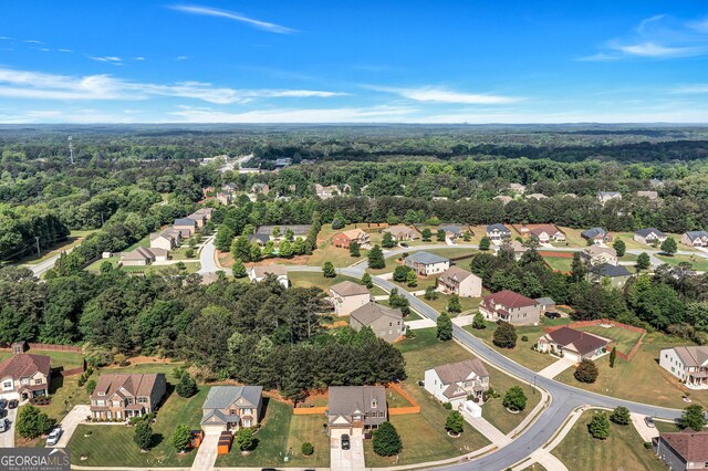 birds eye view of property with a forest view and a residential view