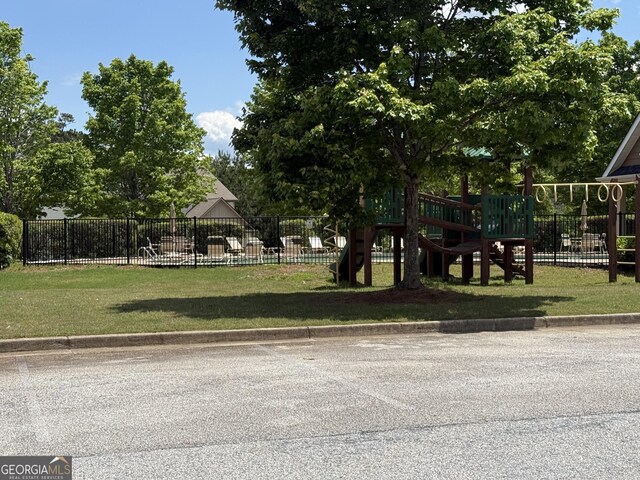community playground with fence and a lawn
