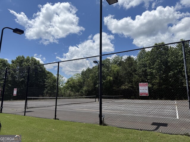 view of tennis court with fence