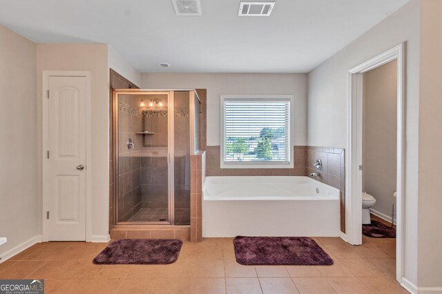 bathroom with visible vents, a stall shower, tile patterned floors, and toilet