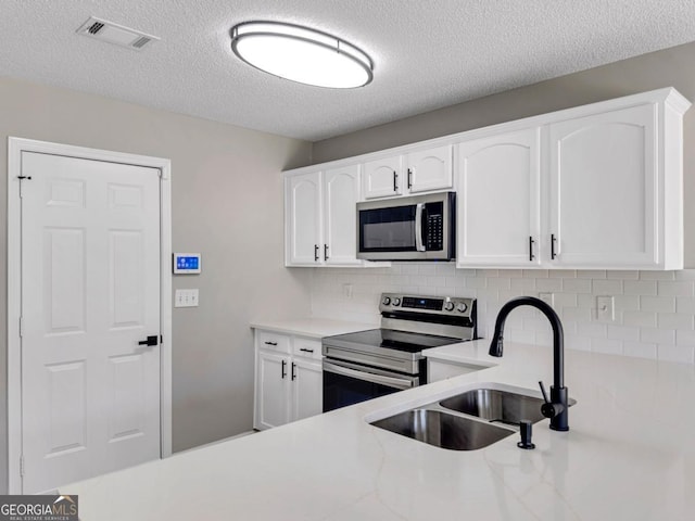 7229 Georges Way, Morrow, GA 30260 - kitchen featuring white cabinetry, stainless steel appliances, decorative backsplash, a sink, and visible vents