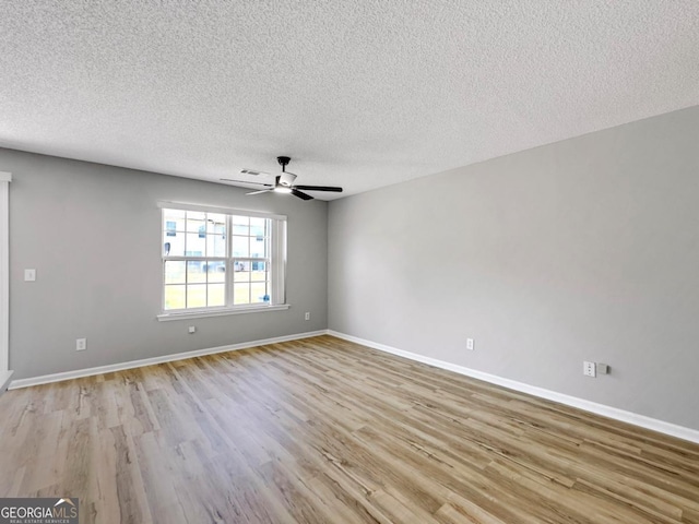 7229 Georges Way, Morrow, GA 30260 - unfurnished room featuring a textured ceiling, baseboards, visible vents, light wood-style floors, and ceiling fan