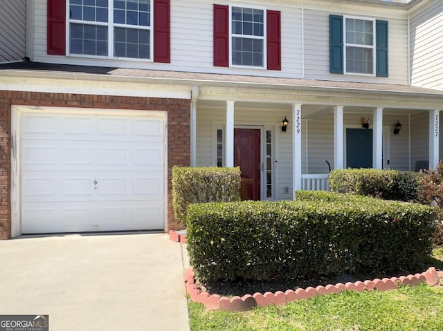7229 Georges Way, Morrow, GA 30260 - view of front of house with brick siding, a garage, concrete driveway, and a porch