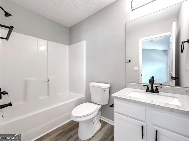 7229 Georges Way, Morrow, GA 30260 - bathroom with vanity, shower / bath combination, toilet, a textured ceiling, and wood finished floors