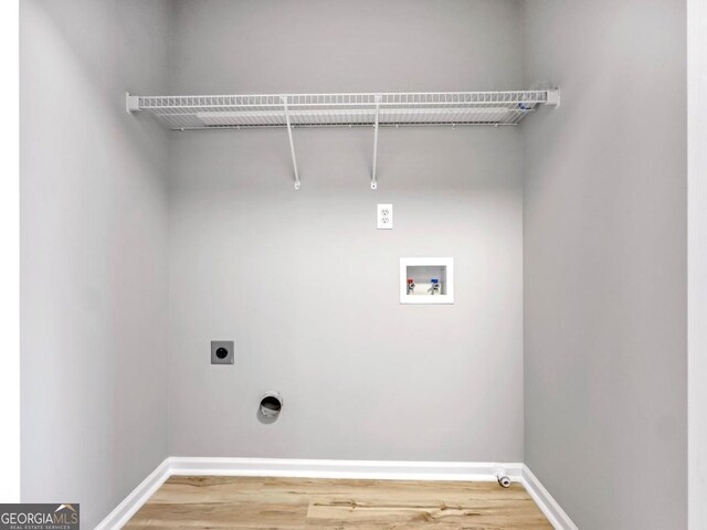 7229 Georges Way, Morrow, GA 30260 - laundry room featuring hookup for an electric dryer, hookup for a washing machine, baseboards, light wood-style floors, and hookup for a gas dryer