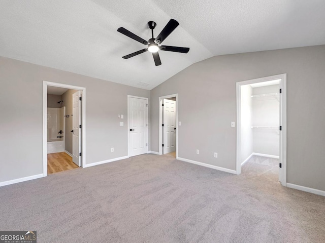 7229 Georges Way, Morrow, GA 30260 - unfurnished bedroom featuring vaulted ceiling, carpet floors, a spacious closet, a textured ceiling, and baseboards
