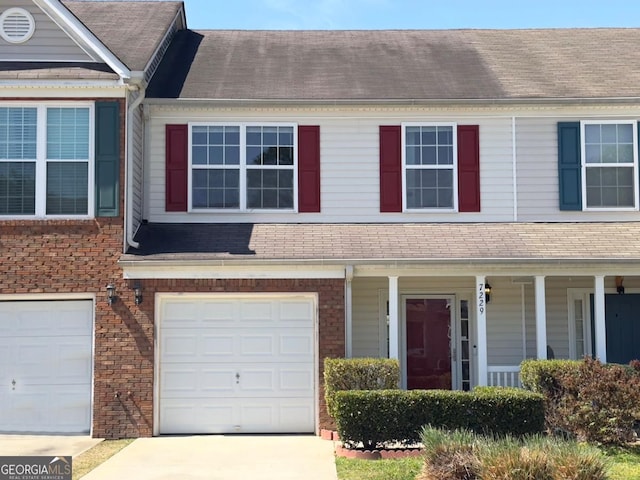 7229 Georges Way, Morrow, GA 30260 - townhome / multi-family property with driveway, a shingled roof, an attached garage, and brick siding