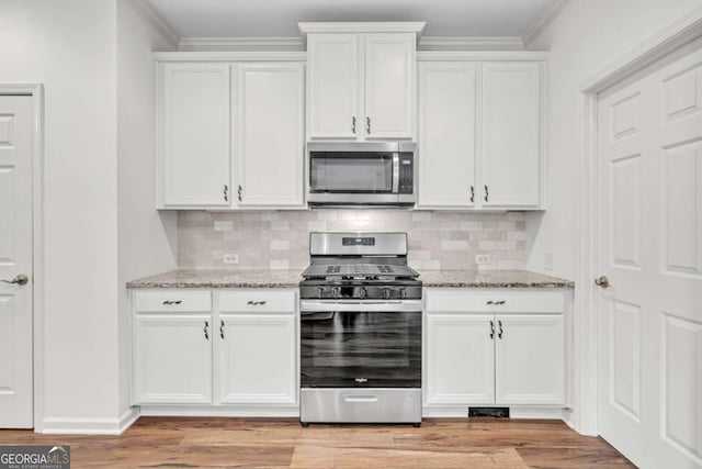 7503 Brookstone Cir, Flowery Branch, GA 30542 - kitchen featuring white cabinets, light stone countertops, and stainless steel appliances