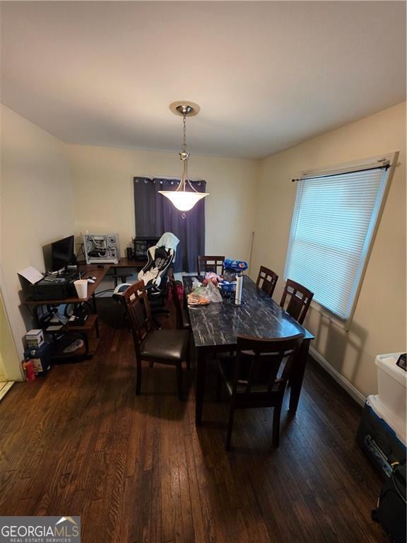 dining area with baseboards and dark wood-style flooring