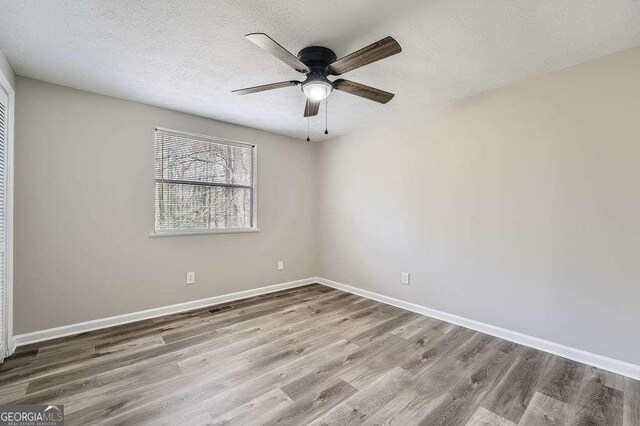 bathroom featuring ornamental molding, a sink, a stall shower, and wood finished floors