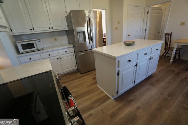 1848 Tenny Nelson Rd, Grantville, GA 30220 - kitchen featuring white cabinetry, tasteful backsplash, stainless steel appliances, a center island, and dark wood-style floors