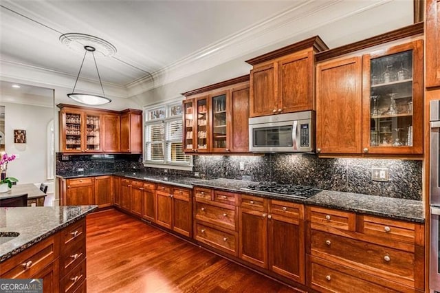 1109 Pine Grove Ave, Brookhaven, GA 30319 - kitchen with stainless steel microwave, gas stovetop, dark wood-style flooring, dark stone countertops, and backsplash