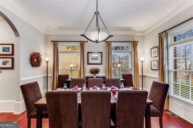 1109 Pine Grove Ave, Brookhaven, GA 30319 - dining space with arched walkways, healthy amount of natural light, wood finished floors, crown molding, and wainscoting