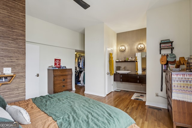 307 Cherokee Ave SE Unit 3, Atlanta, GA 30312 - bedroom with wood finished floors, a spacious closet, a closet, ensuite bathroom, and a ceiling fan